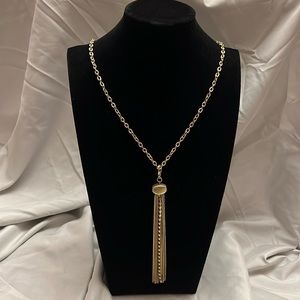 Gold tassel necklace.